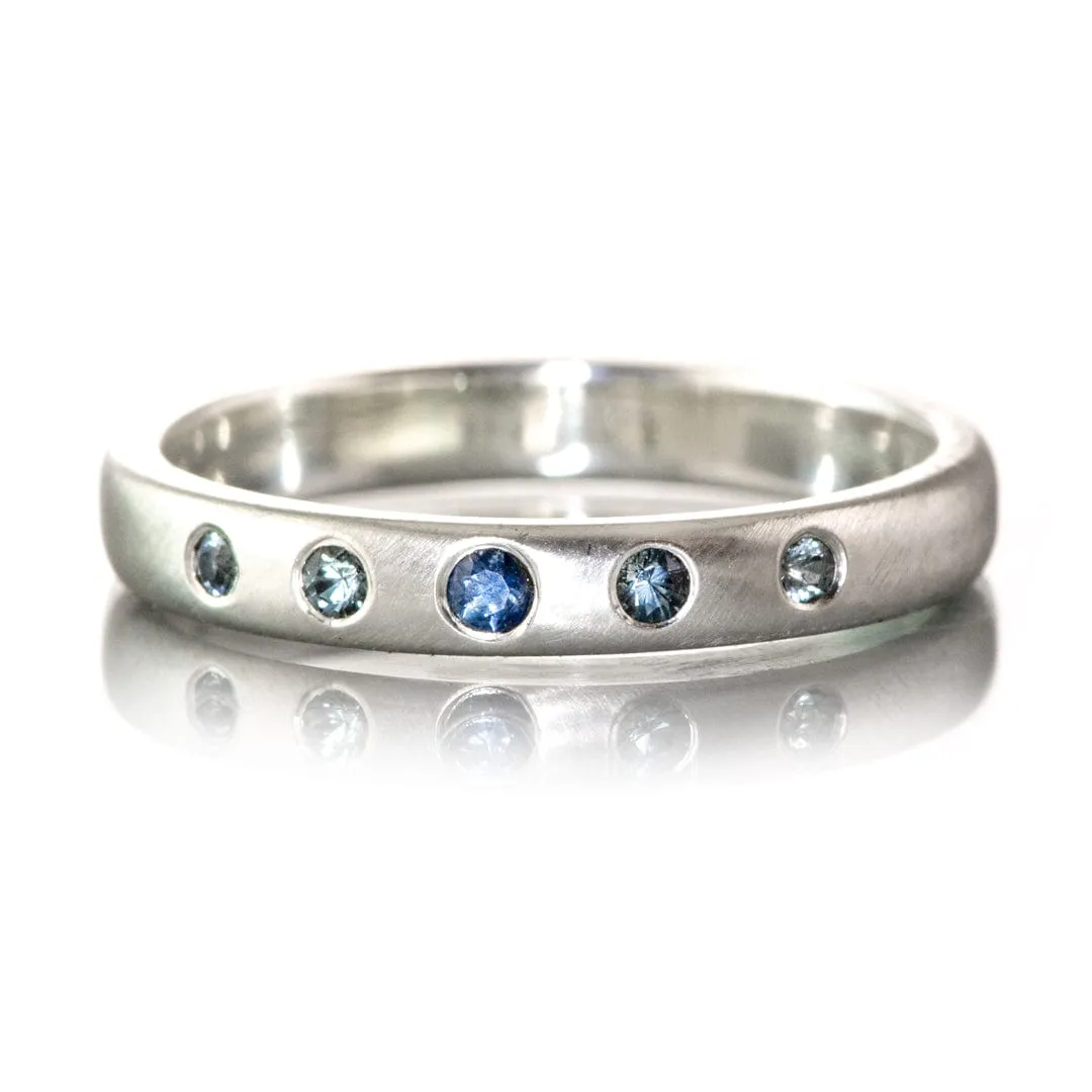 Domed Wedding Band with Graduated Flush set Montana Sapphire