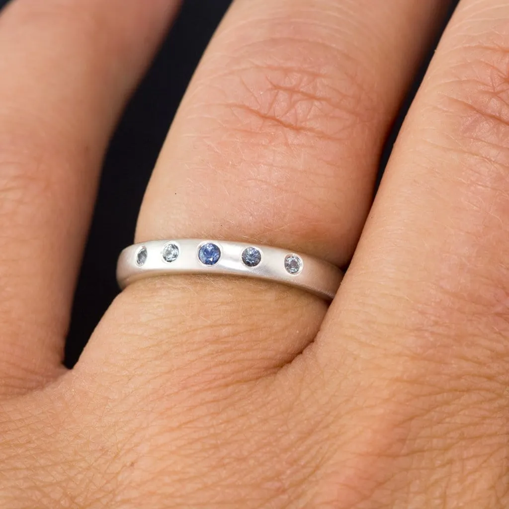 Domed Wedding Band with Graduated Flush set Montana Sapphire